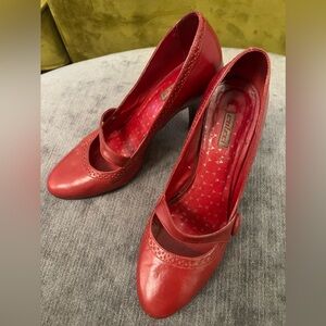 Red leather Mary Jane style pumps with brown leather heel